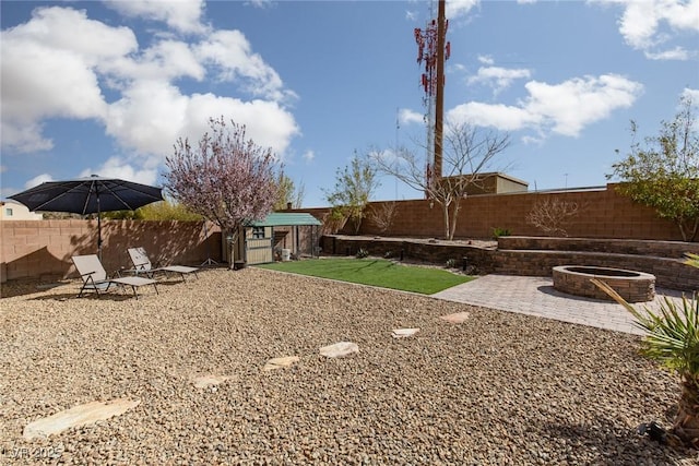 view of yard featuring a patio area, a fire pit, and a fenced backyard