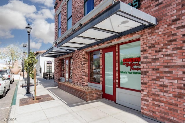 entrance to property featuring brick siding