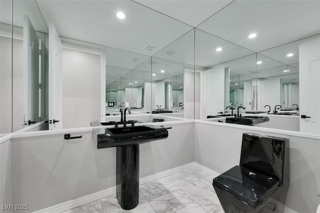 bathroom with recessed lighting and marble finish floor