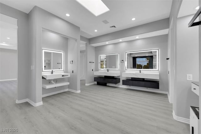 bathroom featuring recessed lighting, wood finished floors, visible vents, and baseboards