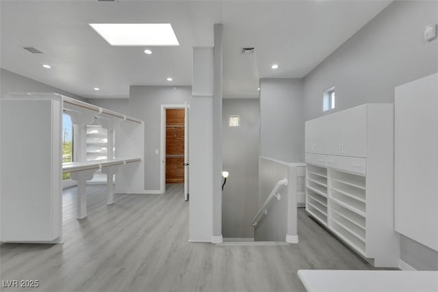 stairs with visible vents, plenty of natural light, and wood finished floors