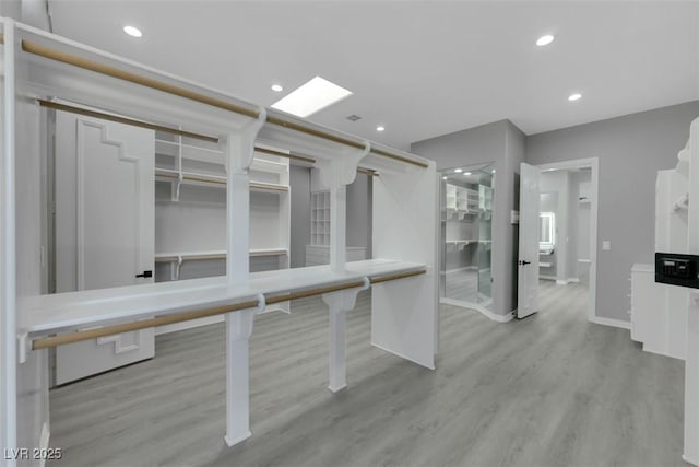 interior space featuring recessed lighting, baseboards, and wood finished floors