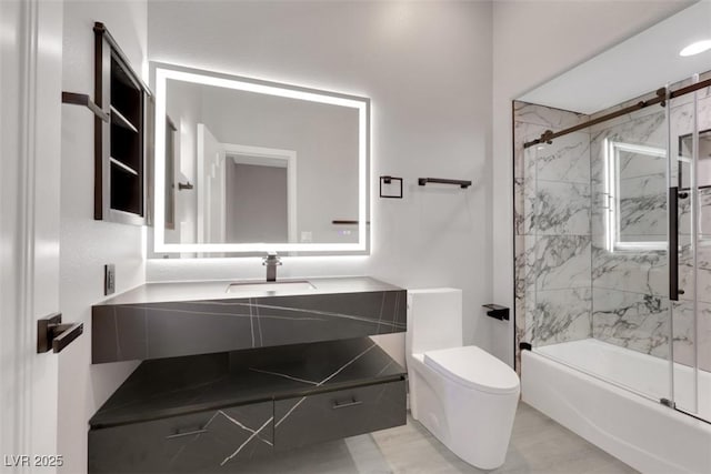 bathroom with toilet, vanity, and shower / bath combination with glass door