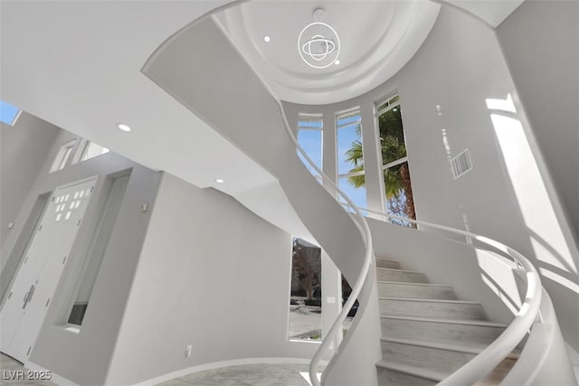 stairs with recessed lighting, marble finish floor, visible vents, and baseboards