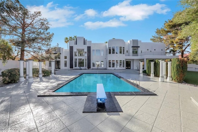 pool featuring a patio and a diving board