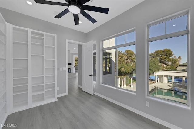 empty room featuring recessed lighting, a ceiling fan, baseboards, and wood finished floors