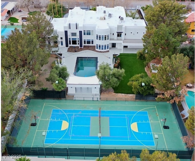 view of sport court with a tennis court, community basketball court, and fence