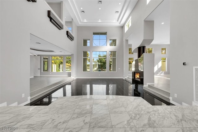 kitchen featuring recessed lighting, a lit fireplace, an AC wall unit, and open floor plan