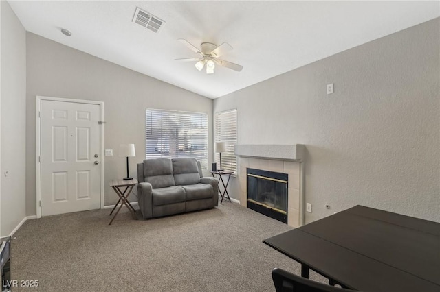 living room with visible vents, carpet floors, a ceiling fan, and vaulted ceiling