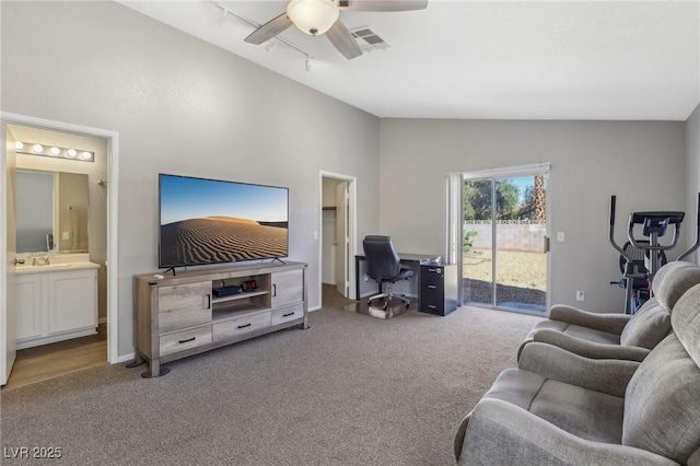 carpeted living room featuring a ceiling fan, visible vents, a sink, vaulted ceiling, and rail lighting