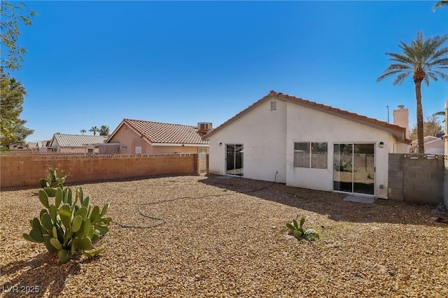 back of house with stucco siding and a fenced backyard