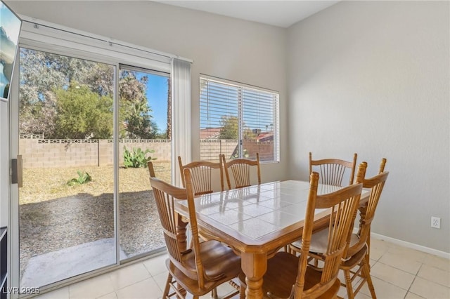 dining room with baseboards and light tile patterned flooring