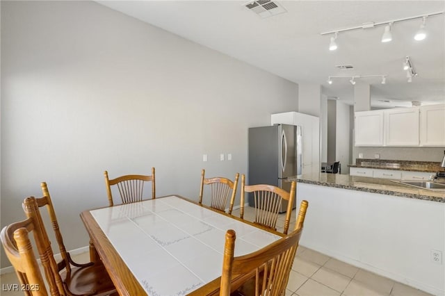 dining area featuring light tile patterned flooring and visible vents