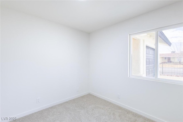 unfurnished room with baseboards and carpet floors