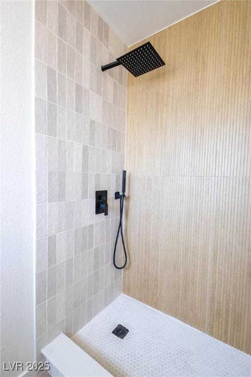 full bath with a tile shower