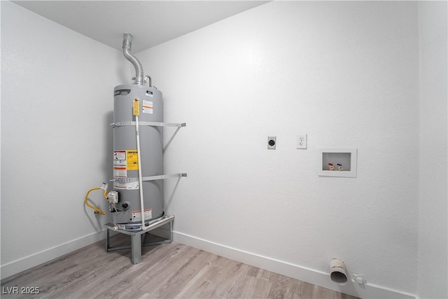 utility room featuring strapped water heater