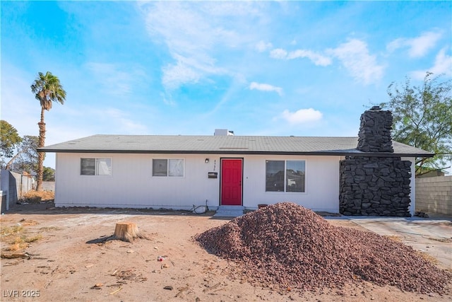 single story home featuring fence and a chimney