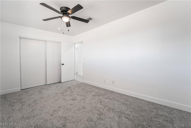 unfurnished bedroom featuring a closet, visible vents, carpet flooring, and baseboards