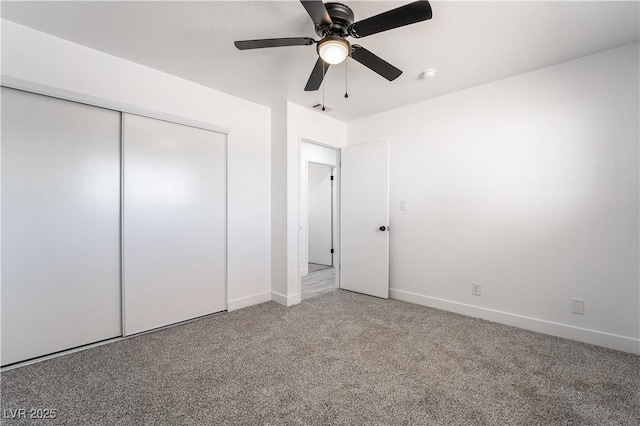 unfurnished bedroom featuring visible vents, baseboards, ceiling fan, a closet, and light carpet