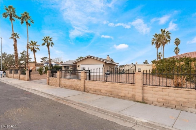 view of front of property featuring a fenced front yard, stucco siding, an attached garage, and concrete driveway