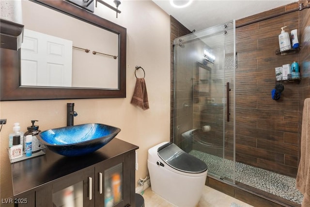 bathroom with vanity, toilet, and a stall shower