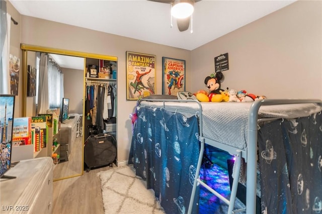 bedroom featuring wood finished floors, a closet, and ceiling fan