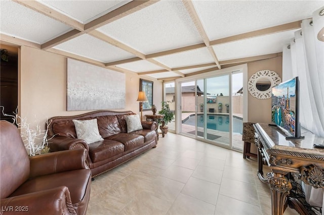 living room featuring beam ceiling, coffered ceiling, and a textured ceiling