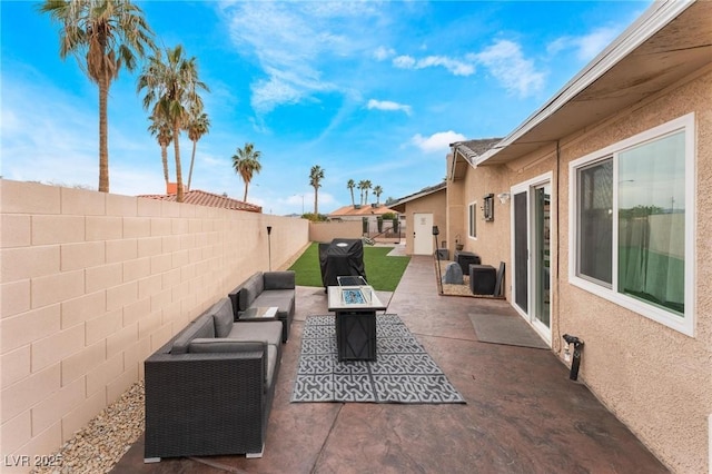 view of patio / terrace featuring area for grilling, an outdoor living space with a fire pit, and a fenced backyard