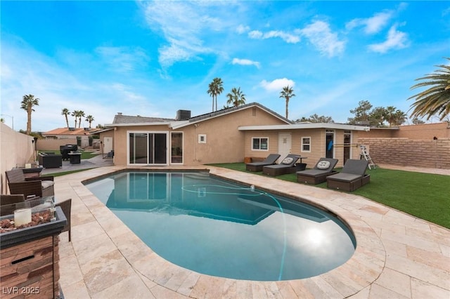 view of swimming pool featuring a fenced in pool, a patio, a fenced backyard, and an outdoor fire pit