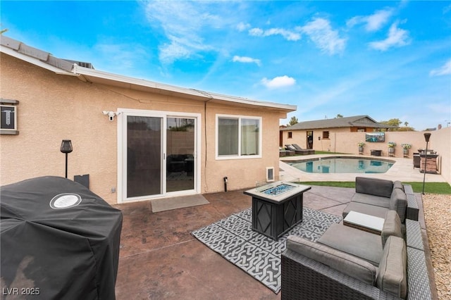 view of patio / terrace with grilling area, a fenced in pool, a fenced backyard, and an outdoor fire pit