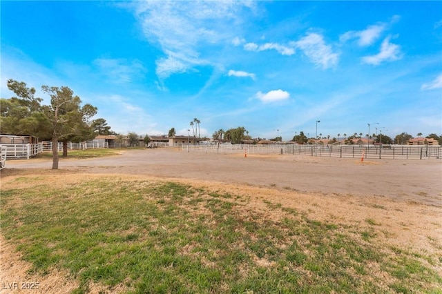 view of yard featuring a rural view and fence