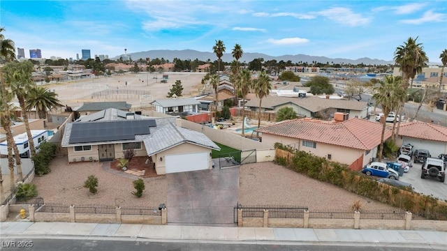 birds eye view of property with a mountain view and a residential view