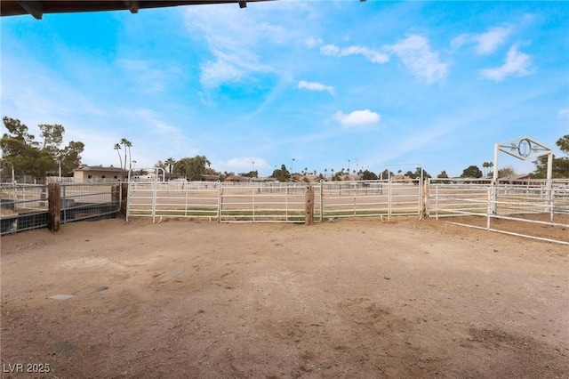 view of yard with a rural view, an exterior structure, and an outdoor structure