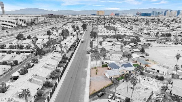 birds eye view of property with a view of city and a mountain view