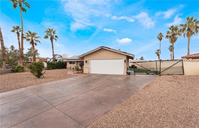 view of front of property with a gate, fence, stucco siding, concrete driveway, and a garage