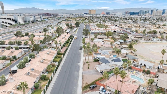 drone / aerial view with a mountain view and a view of city