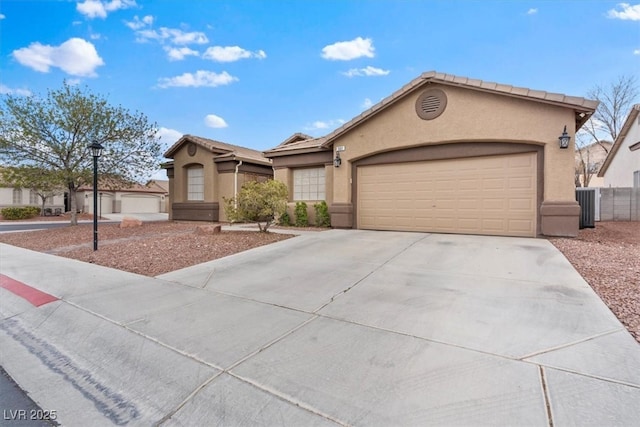 single story home with stucco siding, central AC unit, concrete driveway, and an attached garage