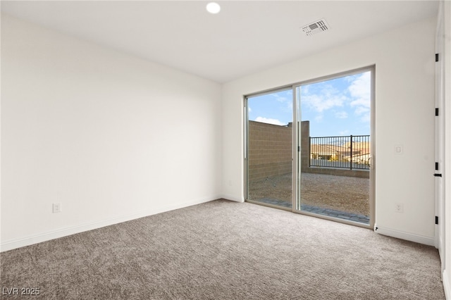 empty room featuring visible vents, baseboards, and carpet flooring