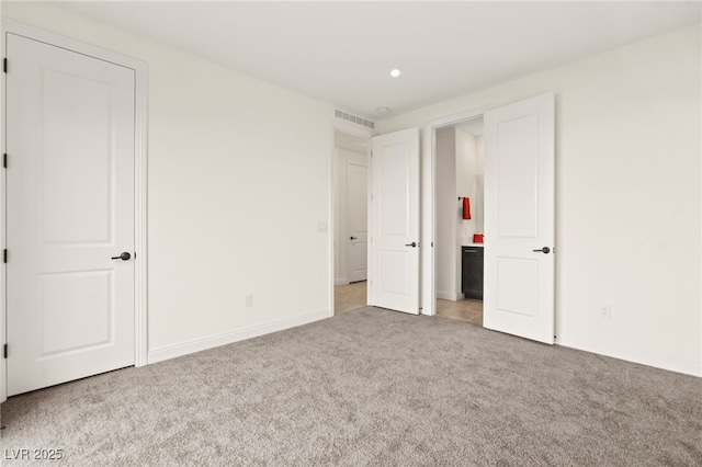 unfurnished bedroom featuring recessed lighting, baseboards, visible vents, and light carpet