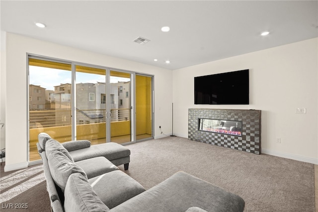 living room with recessed lighting, a fireplace, visible vents, and carpet floors