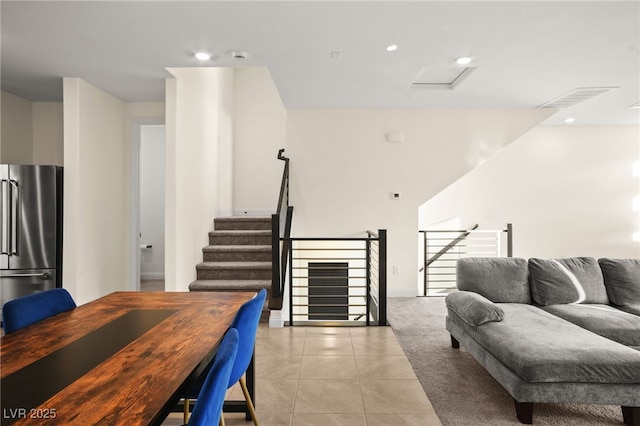 living area with light tile patterned floors, visible vents, and recessed lighting