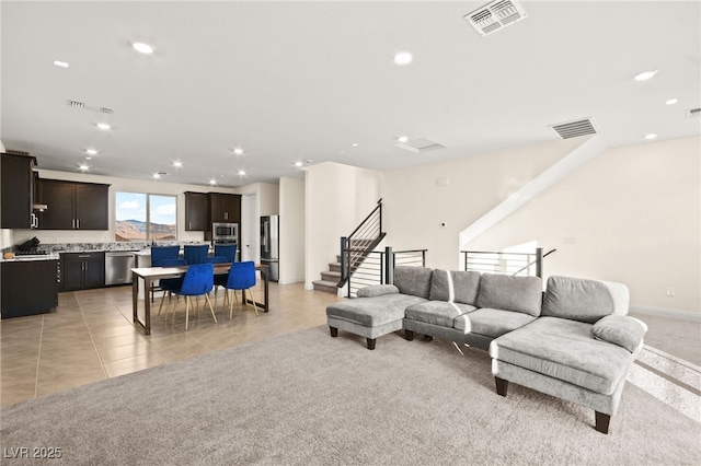 living room featuring light tile patterned flooring, recessed lighting, and visible vents