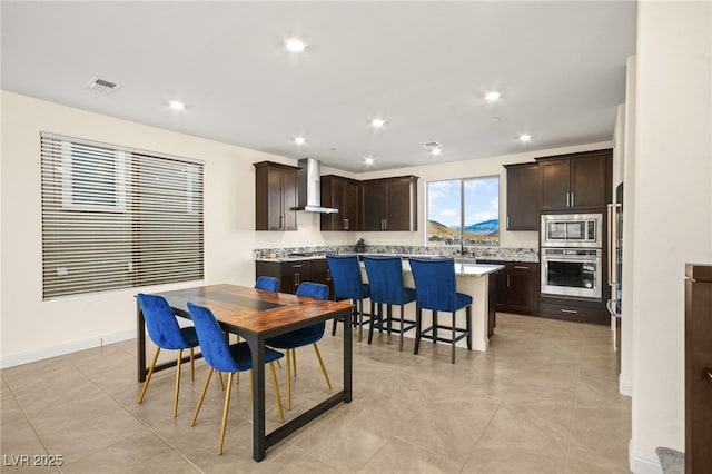 dining area featuring light tile patterned flooring, visible vents, recessed lighting, and baseboards