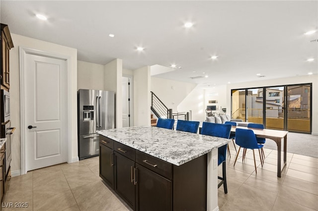 kitchen featuring a breakfast bar, recessed lighting, a kitchen island, and stainless steel appliances