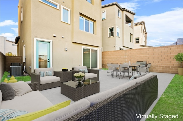 view of patio with outdoor lounge area, cooling unit, fence private yard, and outdoor dining area