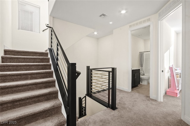 stairway featuring visible vents, recessed lighting, baseboards, and carpet floors