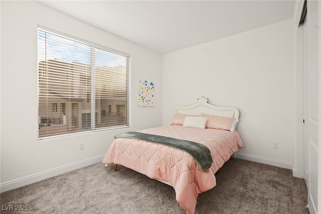 bedroom featuring carpet flooring, baseboards, and a closet