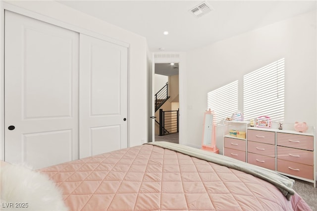 bedroom with a closet, carpet flooring, and visible vents