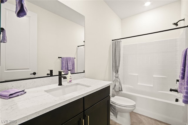 full bath with tile patterned floors, toilet, vanity, and shower / bath combo