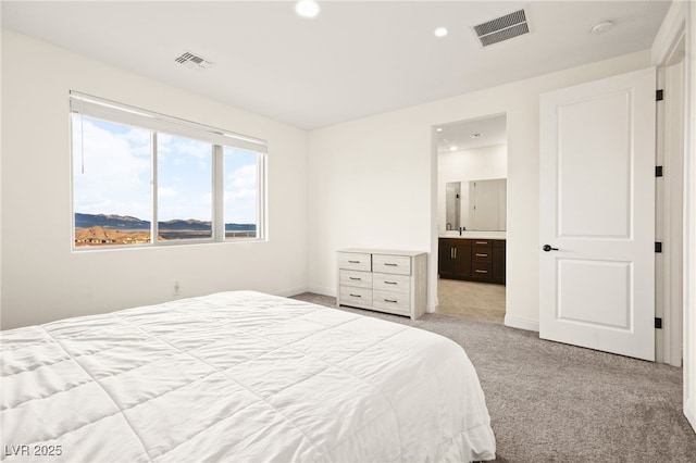 bedroom with recessed lighting, visible vents, light carpet, and baseboards